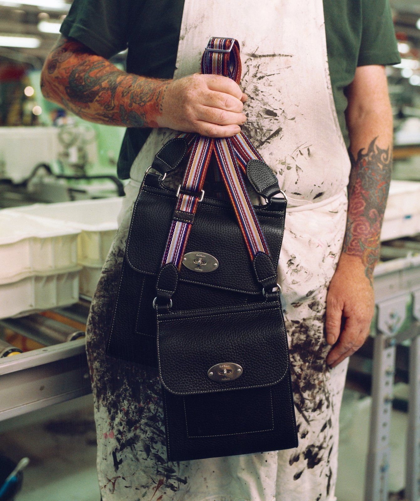 mullberry worker holding mulberry paul smith antony and small antony bags in black